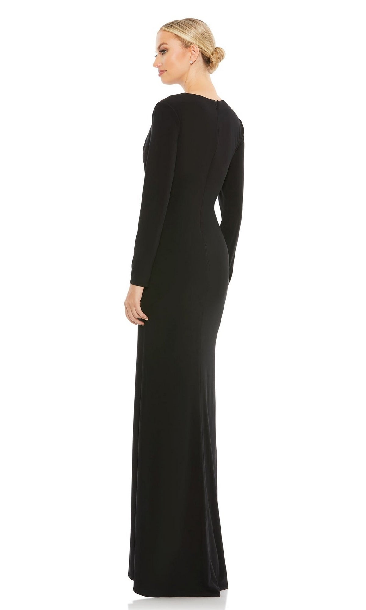 A woman in profile wears the Mac Duggal 26686, a long-sleeve formal dress with a floor-length black skirt, her hair styled in a low bun.